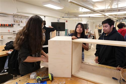 Students working on cabinet building.