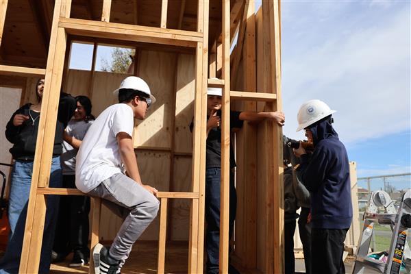 Students worked on adding wall sheathing to the framing.