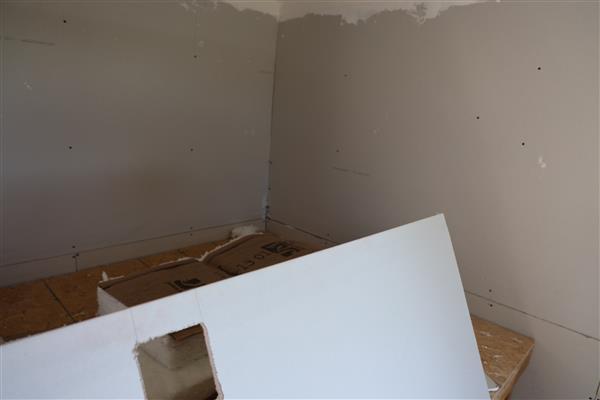 Working on cutting and handing the drywall.