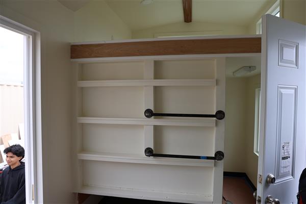 Shelves and bars to set things on, there is also a queen size trundle that pulls out at the very bottom.