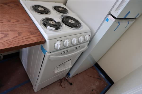 The stove and refrigerator have been placed in the kitchen.